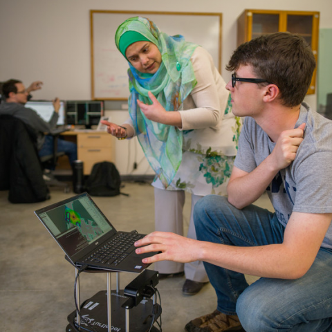 two people looking at laptop